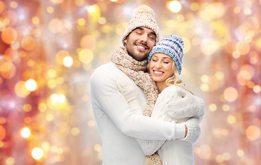 Image showing smiling couple in winter clothes hugging