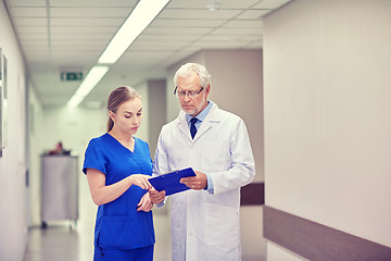 Image showing senior doctor and nurse with tablet pc at hospital