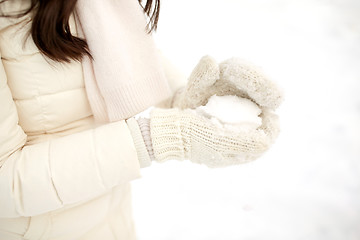 Image showing close up of woman with snowball in winter