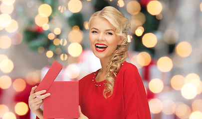 Image showing happy woman in red dress with christmas gift box