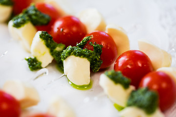 Image showing close up of mozzarella and cherry tomato canape