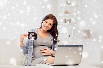 Image showing pregnant woman with ultrasound image and laptop