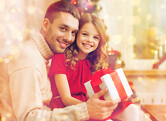 Image showing smiling father and daughter holding gift box