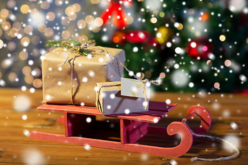 Image showing close up of christmas gift boxes on wooden sleigh