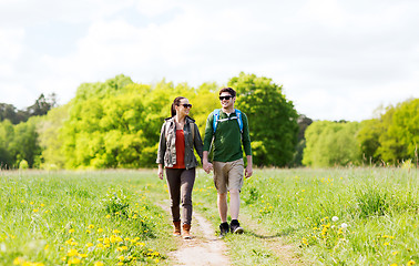 Image showing happy couple with backpacks hiking outdoors