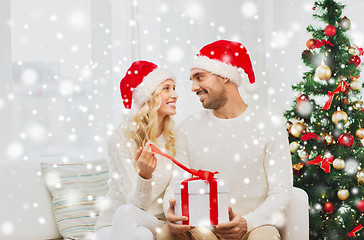 Image showing happy couple at home with christmas gift box