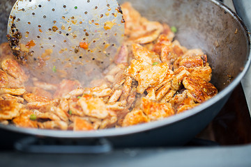 Image showing close up of meat in wok pan at street market