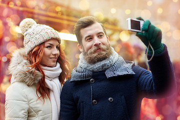 Image showing couple taking selfie with smartphone in old town