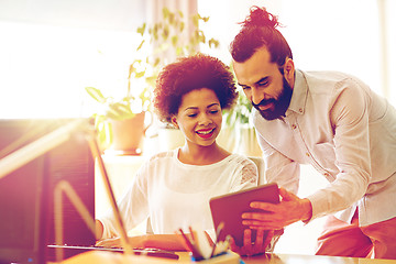 Image showing happy creative team with tablet pc in office