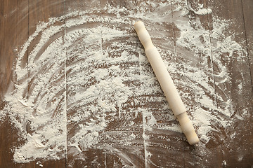 Image showing Scattered flour on wooden table.