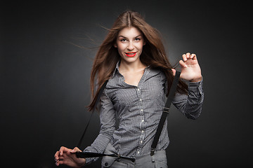 Image showing Happy woman pulling suspenders.