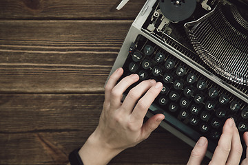 Image showing Writer typing with retro writing machine.