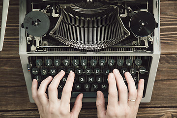 Image showing Writer typing with retro writing machine.