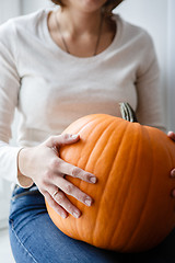 Image showing Woman holding pumpkin