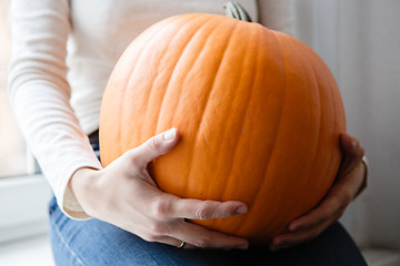 Image showing Woman holding big pumpkin