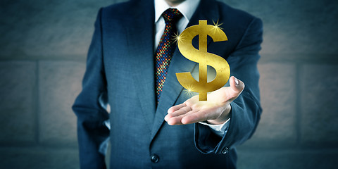 Image showing Business Manager Offering A Golden Dollar Symbol