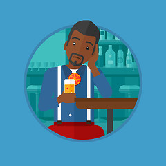 Image showing Man drinking orange cocktail at the bar.