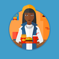 Image showing Woman with tray full of fast food.