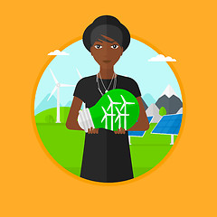 Image showing Woman holding lightbulb with wind turbines inside.