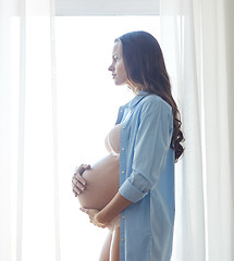 Image showing happy pregnant woman with big bare tummy at home