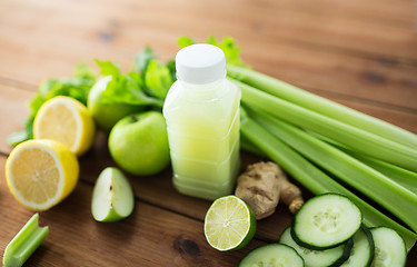 Image showing close up of bottle with green juice and vegetables