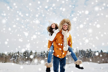 Image showing happy couple having fun over winter background