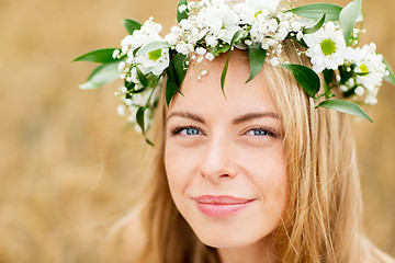 Image showing happy woman in wreath of flowers