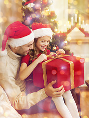 Image showing smiling father and daughter opening gift box