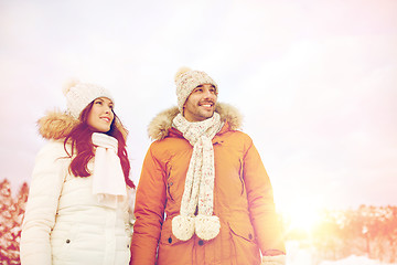 Image showing happy couple walking over winter background