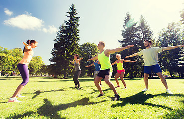 Image showing group of happy friends exercising outdoors