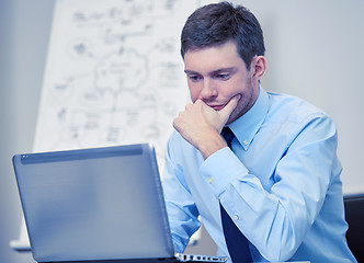 Image showing businessman sitting with laptop in office