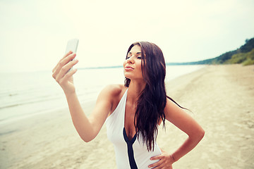 Image showing young woman taking selfie with smartphone