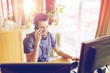 Image showing happy creative male worker calling on smarphone