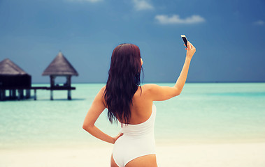 Image showing young woman taking selfie with smartphone