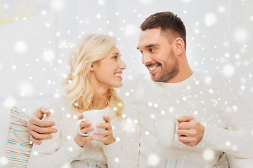 Image showing happy couple with cups drinking tea at home