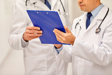 Image showing close up of doctors with clipboard at hospital