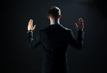 Image showing businessman touching virtual screen