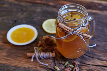 Image showing Tea with lemon and honey on the wooden background.