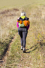 Image showing Young woman walking by hiking trail