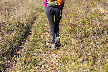 Image showing Young woman walking by hiking trail