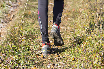 Image showing Young woman walking by hiking trail