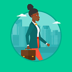 Image showing Successful business woman walking with briefcase.