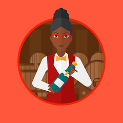 Image showing Waitress holding bottle in wine cellar.