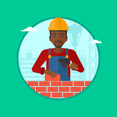 Image showing Bricklayer with spatula and brick.