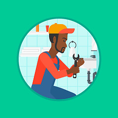 Image showing Plumber fixing sink pipe with wrench.