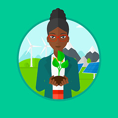 Image showing Woman holding green small plant.