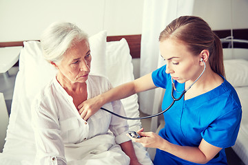 Image showing nurse with stethoscope and senior woman at clinic