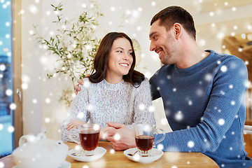 Image showing happy couple drinking tea at restaurant