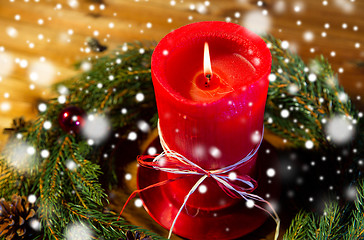 Image showing fir branch wreath with candle on wooden table