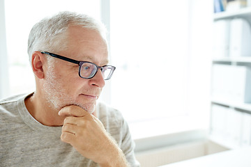 Image showing close up of senior man in glasses thinking
